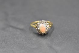 An opal and diamond cluster ring on an 18ct gold loop, size N & approx 3.6g