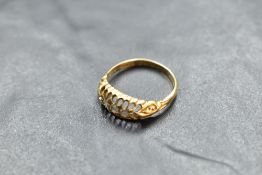 A five stone graduated diamond ring in a boat claw set mount on an 18ct gold loop, size P & approx
