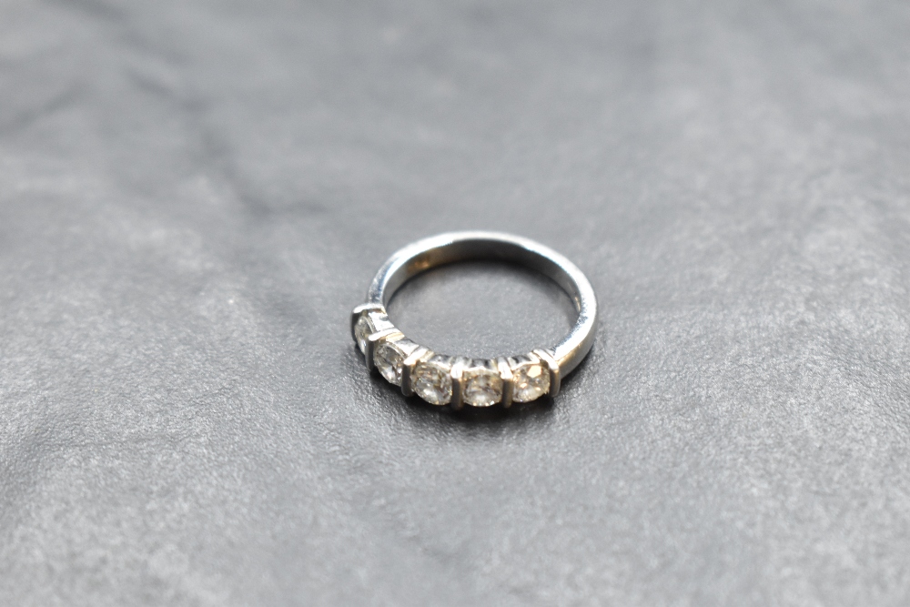 A five stone brilliant cut diamond eternity ring, approx 1.25ct in a bar set mount on a platinum