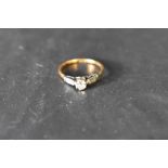 A diamond solitaire ring approx 0.25ct in a raised claw set mount having diamond chip set