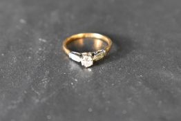 A diamond solitaire ring approx 0.25ct in a raised claw set mount having diamond chip set