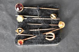 Seven assorted yellow metal stick pins including 9ct & 15ct gold