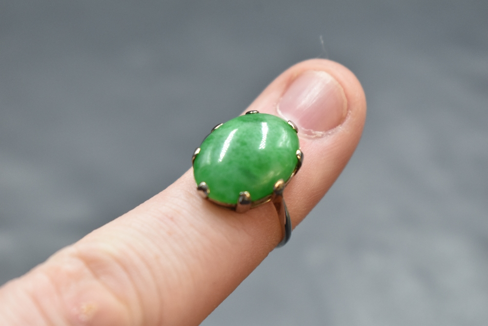 A jade style oval cabochon ring in a claw set mount on a white metal loop stamped 18ct, size L & - Image 2 of 2