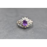 An amethyst and diamond open cluster ring with diamond set shoulders, all in illusionary mounts,