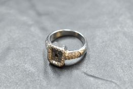 A 750 grade white metal diamond set signet ring, the rectangular platform set with baguette diamonds