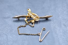 A 15ct gold bar brooch having a central open heart with seed pearl decoration, approx 2.9g