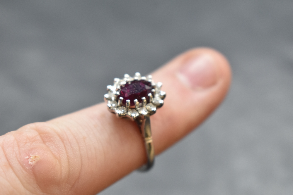 A ruby and diamond cluster ring in a claw set stepped mount on an 18ct white gold loop, size M & - Image 2 of 2