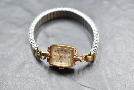 A lady's vintage 9ct gold wrist watch by Rotary having Arabic numeral dial to rectangular face in