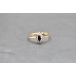 A small sapphire and diamond oval cluster ring on a 9ct gold loop, size P & approx 1.4g