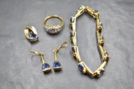 A three piece set of gold plated silver jewellery having blue stones, and a matched gold plated