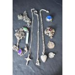 A selection of silver and white metal pendants, several stamped silver including St Christopher, WI,