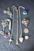 A selection of silver and white metal pendants, several stamped silver including St Christopher, WI,