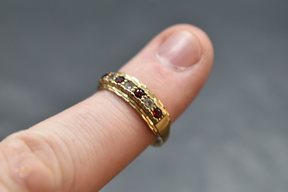 A seven stone garnet and cubic zirconia band ring having cut detail to mount and a 9ct gold loop, - Image 2 of 2