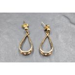 A pair of 9ct gold stud earrings having pierced loop drops, approx 2.9g