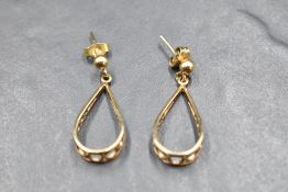 A pair of 9ct gold stud earrings having pierced loop drops, approx 2.9g