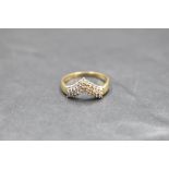 A triple row diamond wishbone ring having 33 stones, total approx 0.5ct on a 9ct gold loop, size P &