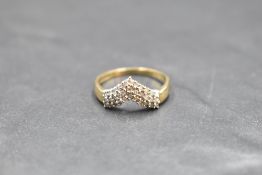 A triple row diamond wishbone ring having 33 stones, total approx 0.5ct on a 9ct gold loop, size P &