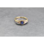 An early 20th century sapphire and diamond ring having a central oval sapphire flanked by six old