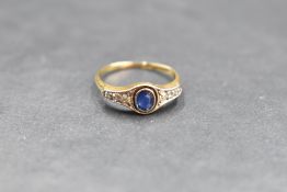 An early 20th century sapphire and diamond ring having a central oval sapphire flanked by six old