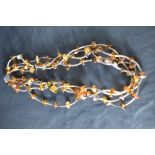 A four strand silver and amber collarette necklace