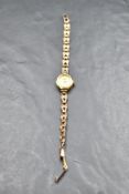 A 9ct gold wrist watch by Everise having baton numeral dial to small oval face with a 9ct gold