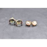 A pair of 15k yellow metal and alexandrite type earrings, the oval stones claw set, marked 14k to