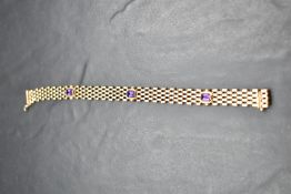 A 9ct gold brick link bracelet having three inset amethysts and a slide clasp, approx 185mm & 10.4g