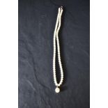 A 750 grade white metal and cultured pearl necklace, the clasp marked 750,44cm overall.