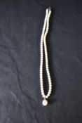 A 750 grade white metal and cultured pearl necklace, the clasp marked 750,44cm overall.
