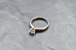 A diamond solitaire ring, approx 0.35ct in a four claw raised mount on an 18ct white gold loop, size