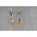 A pair of 9ct gold stud earrings having pierced drops with central citrines, approx 2.3g