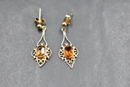 A pair of 9ct gold stud earrings having pierced drops with central citrines, approx 2.3g