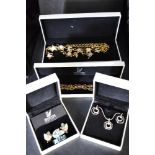 A selection of Swarovski jewellery including swan brooch, moon and stars set, leaf brooch with