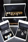 A selection of Swarovski jewellery including swan brooch, moon and stars set, leaf brooch with