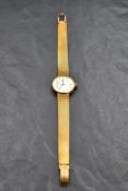 A lady's 1960's 18ct gold wrist watch by Omega, movement no: 24096512, having baton numeral dial
