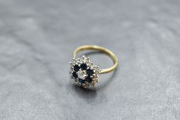 A sapphire and diamond triple daisy cluster ring having central brilliant cut diamond approx 0.