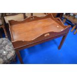 A reproduction mahogany butlers tray style side table