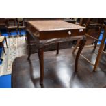 A traditional oak nest of three tables