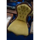 A Victorian mahogany nursing chair having knurl frame and gold dralon upholstery
