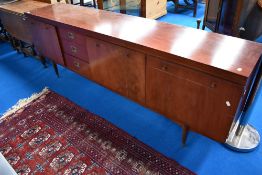 A vintage mahogany Long John style sideboard having cupboards to end with three drawers and drop