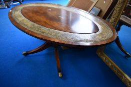 A reproduction Regency style oval coffee table