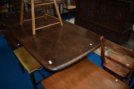 A dark stained Ercol refectory style dining table