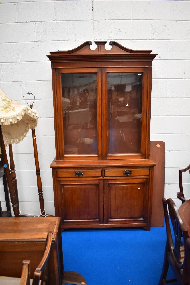 A Victorian mahogany bookcase having double drawer and cupboard under