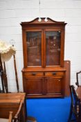 A Victorian mahogany bookcase having double drawer and cupboard under