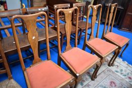 A set of four early 20th Century oak dining chairs having Queen Anne style legs