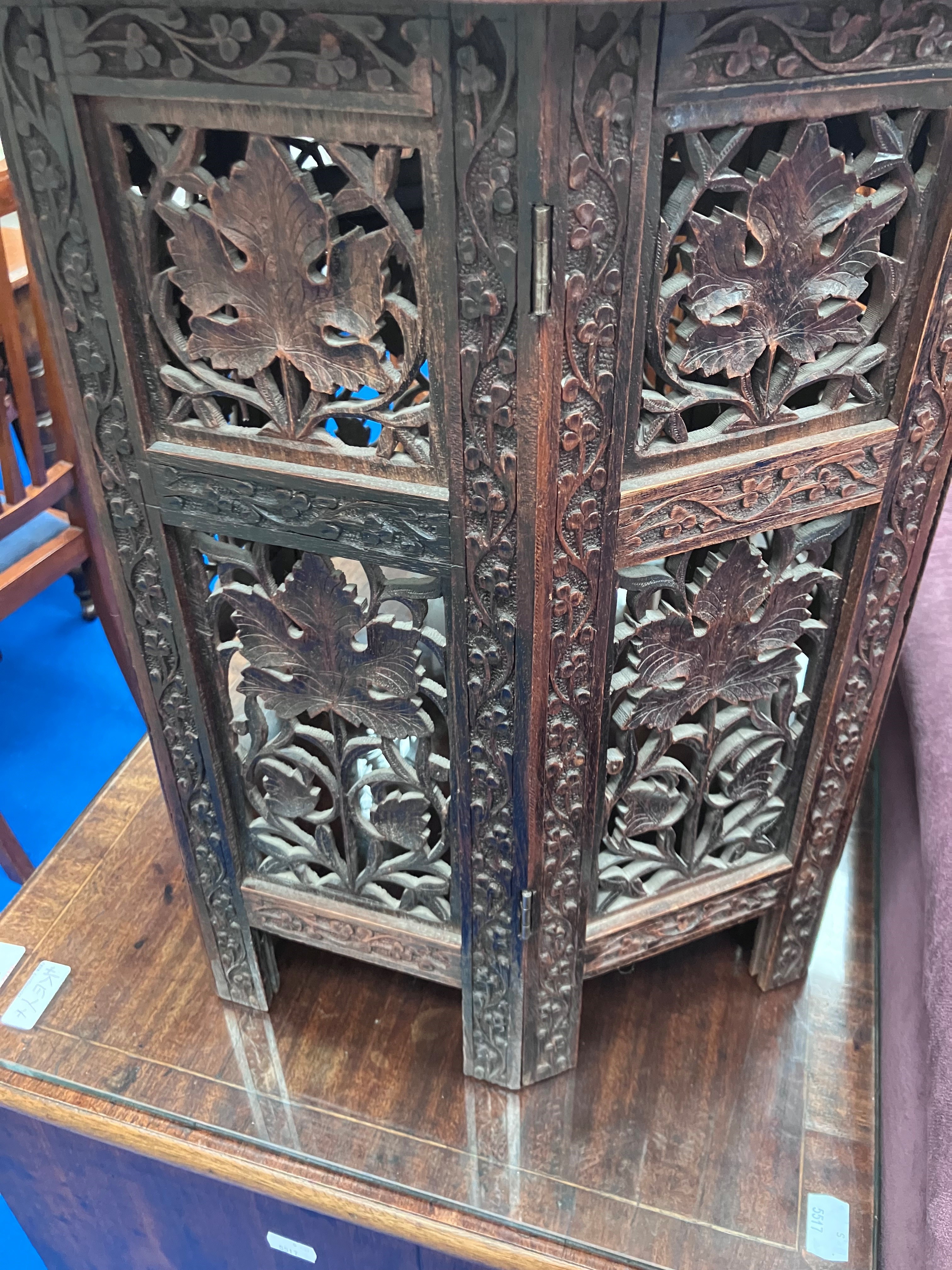 An Eastern style occasional table with carved decoration to top and to folding frame - Image 3 of 3