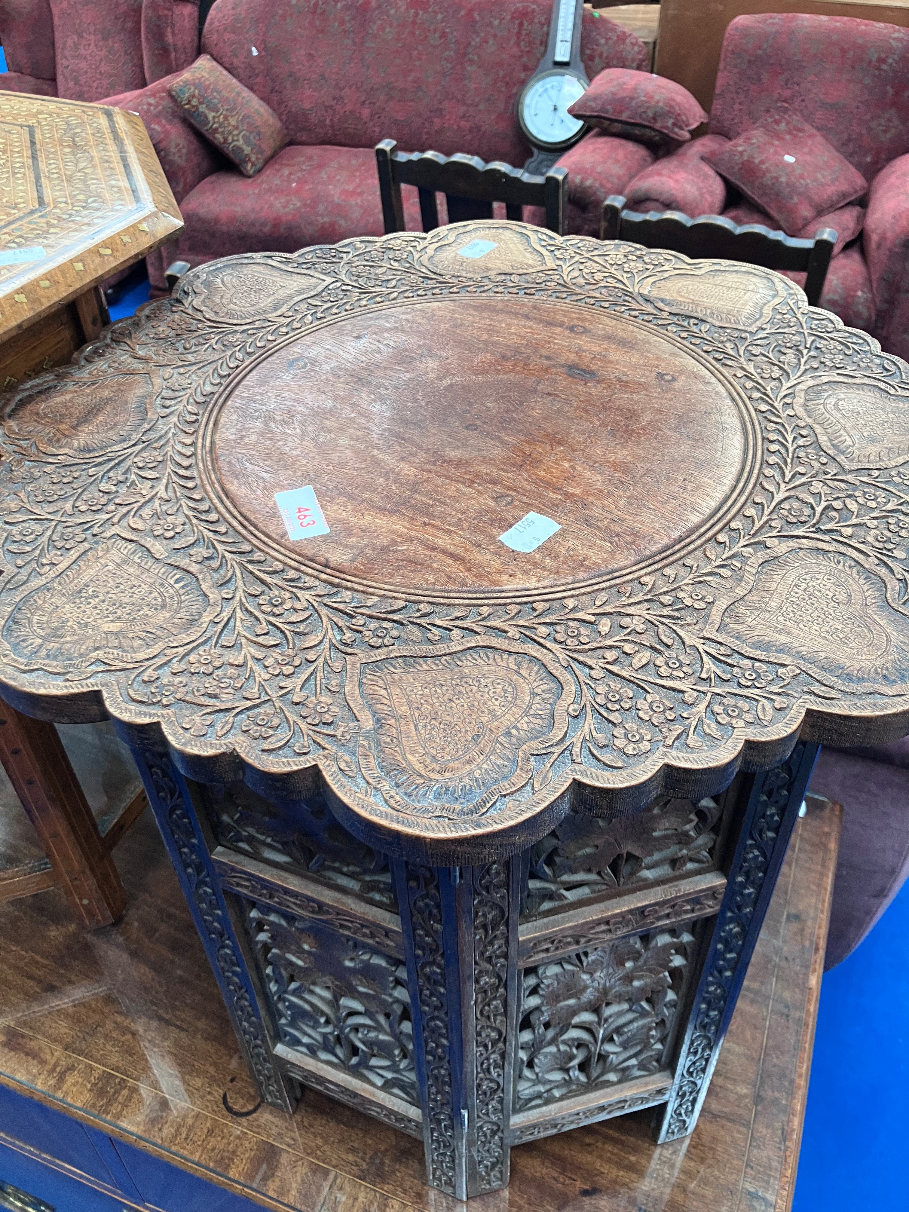 An Eastern style occasional table with carved decoration to top and to folding frame - Image 2 of 3