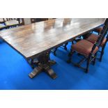 A very nice quality reproduction oak banquetting dining table having plank top and heavy carved cup
