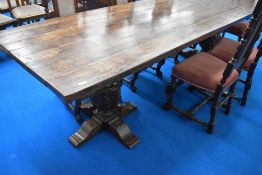 A very nice quality reproduction oak banquetting dining table having plank top and heavy carved cup