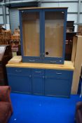 A large kitchen or similar display unit with base cupboards, blue/grey and beech effect finish